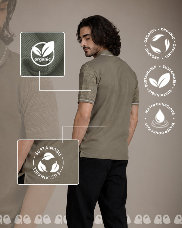 Man wearing a green t-shirt with organic and sustainable labels on a brown background